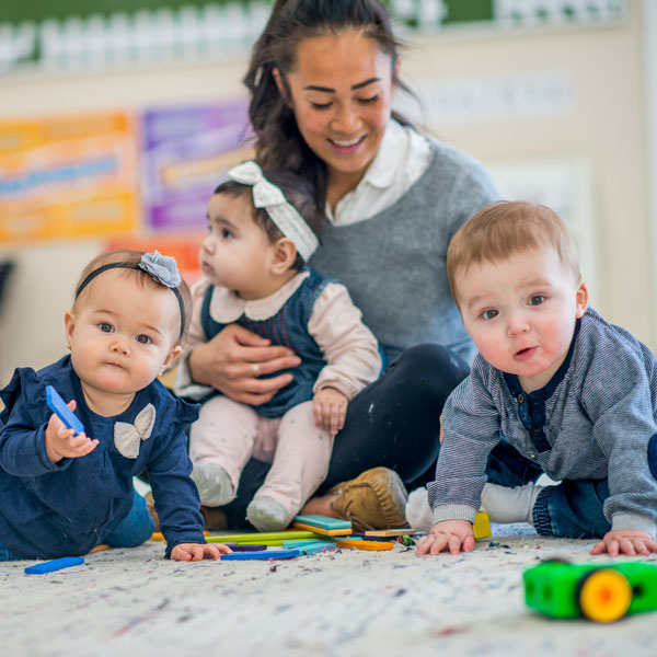 Teacher taking care of infants