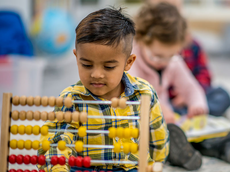 boy playing with abacus