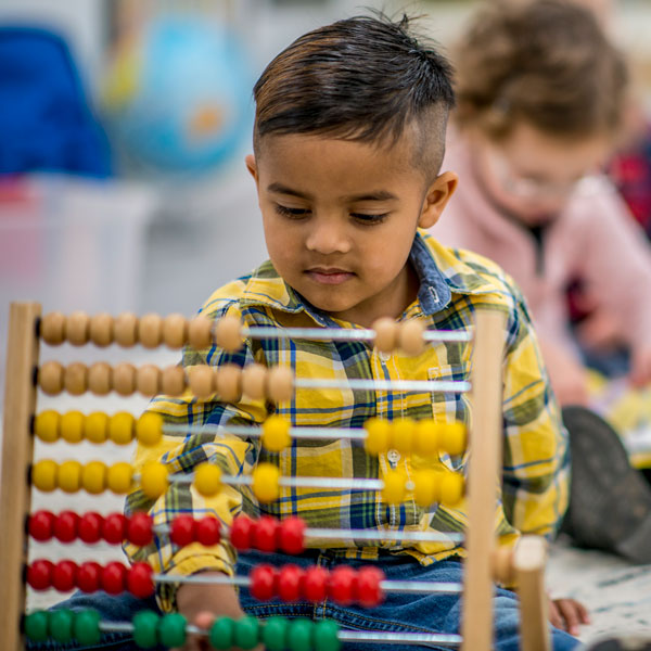 Little boy playing with abacus