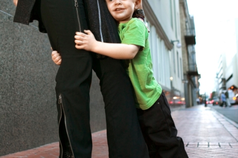 Preschool child clinging to parent's leg