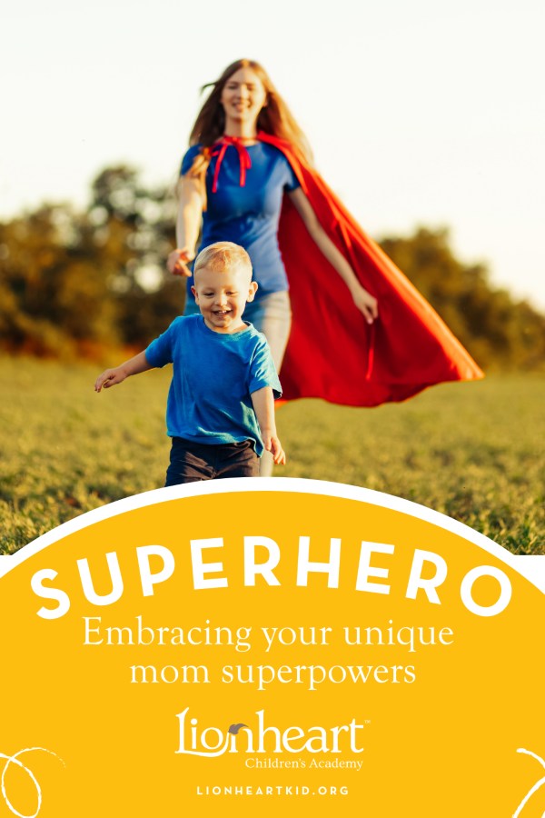 Joyful young boy running through an open field while his mother chases after him