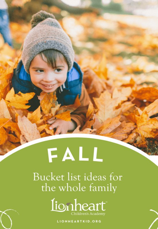 Child playing in leaves in autumn