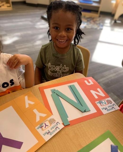 Children learning literacy skills at Lionheart Children's Academy