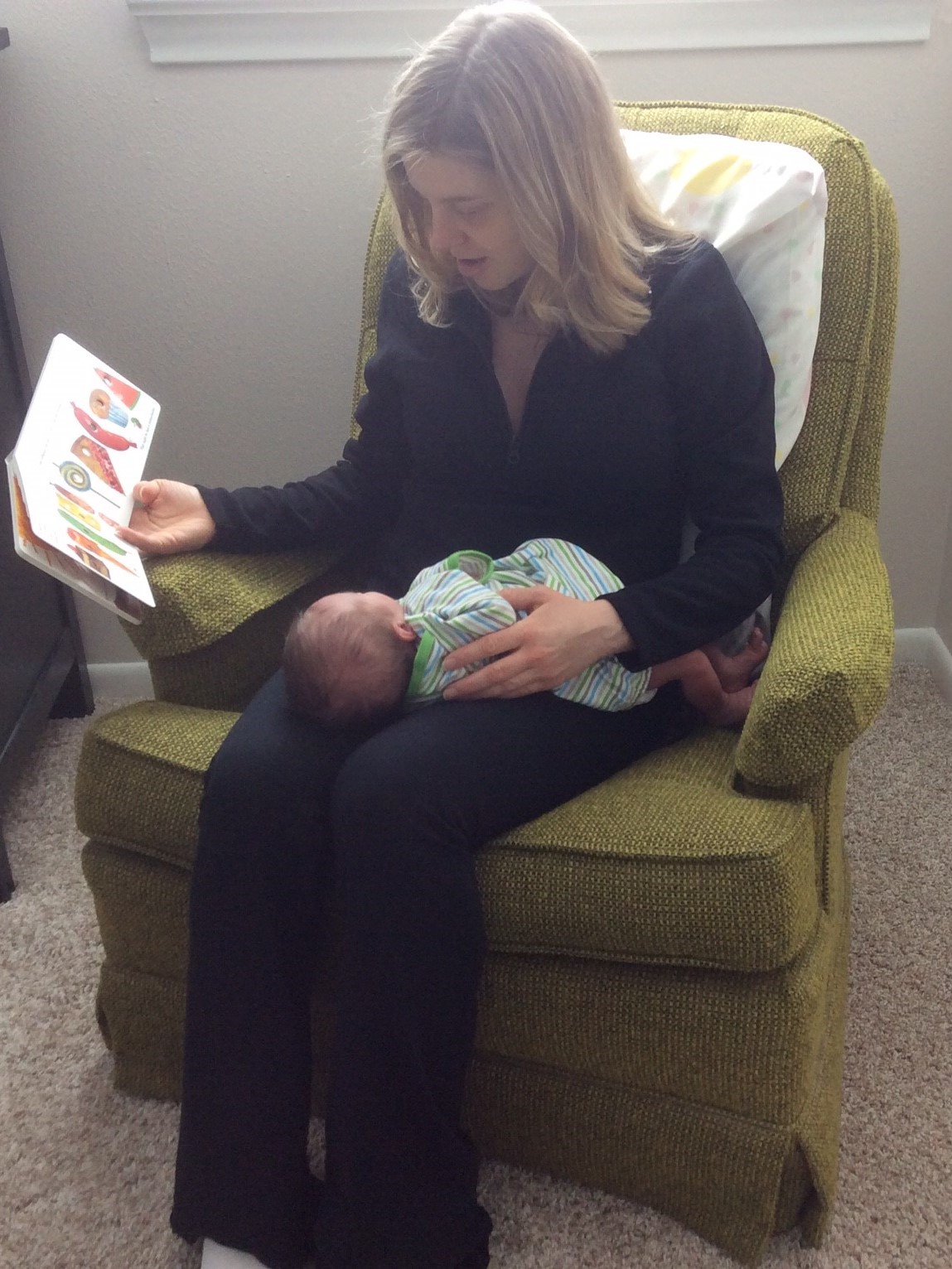 A mom reads to her newborn