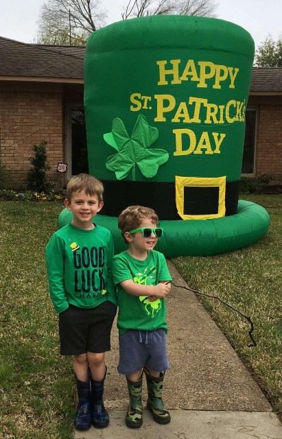 Two boys with a giant leprechaun hat during the neighborhood scavenger hunt in Texas